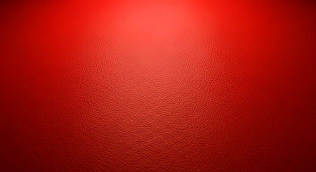 Vibrant red textured background with a subtle spotlight effect creating a warm and inviting atmosphereの素材