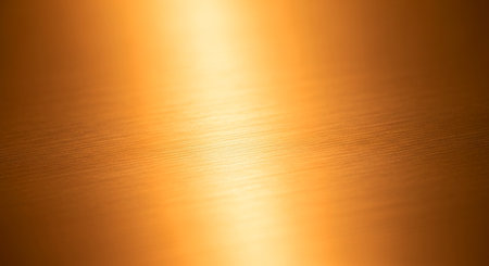 Brushed gold metal texture with diagonal light and shadowの素材