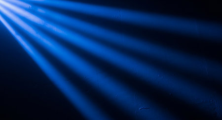 Blue rays of light on a dark blue background. Abstract background.の素材