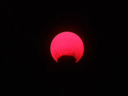 Red sun in the dark sky, Thailand. Red sun on black background.
