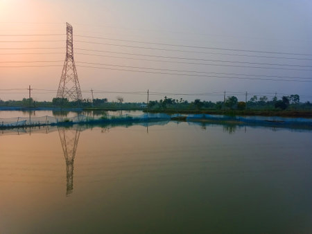 High-voltage pylons in the countryside at sunset.の写真素材