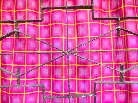 abstract background or texture of a colorful fabric with a metal grid