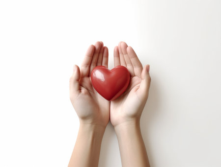 Hands holding red heart on white background, top view. Charity conceptの素材