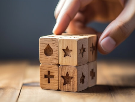 Hand putting wooden blocks with star icon on top of each other.の素材