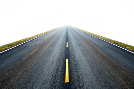 Asphalt road with yellow line on the white background, travel conceptの素材