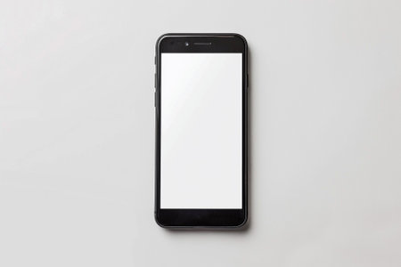 Smartphone with blank screen isolated on white background. Top view.の素材