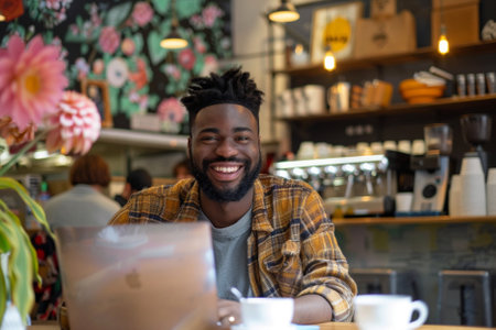 Portrait of smiling african american man sitting in coffee shopの素材