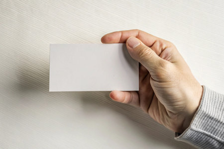 Hand holding blank business card isolated on white Minimal flat background