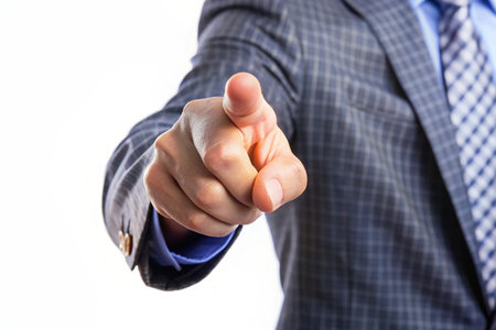Businessman pointing with his finger on white background. Closeup.