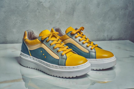 Stylish elegant trendy designer fashionable women's sneakers isolated on white backgroundの写真素材