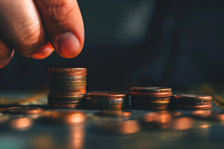 Man hand putting coin to money, business and finance concept idea.の写真素材