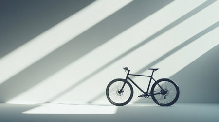 Silhouette of a bicycle on white background with shadow from sunlightの写真素材