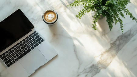 Laptop computer, coffee cup and green plantle table.