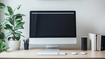 Close up of modern workspace with blank computer screen, stationery and houseplant on wooden table....
