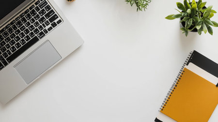White office desk table with laptop, smartphone and supplies. Top view with copy space, flat lay