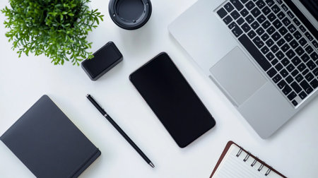 White office desk table with laptop, smartphone, notebook and coffee cup. Top view with copy spaceの写真素材
