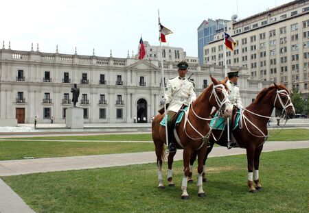 Presidential guards on horses at the parade grounds of Palacio de La Moneda Santiago Chile.のeditorial素材