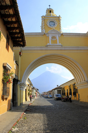 An arch with a clock in the city of Antigua Guatemalaのeditorial素材