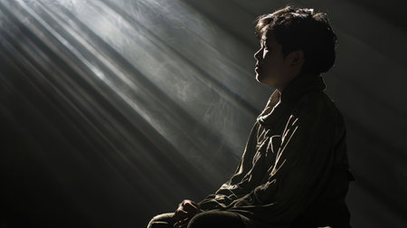 A deeply emotive scene with dramatic chiaroscuro lighting conveys a sense of depth character and introspectionの素材