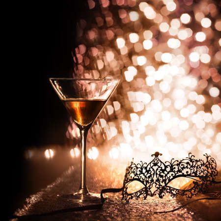 carnival mask and glass with glittering backgroundの写真素材