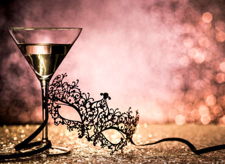 Carnival mask and cocktail with copy space on glittering backgroundの写真素材