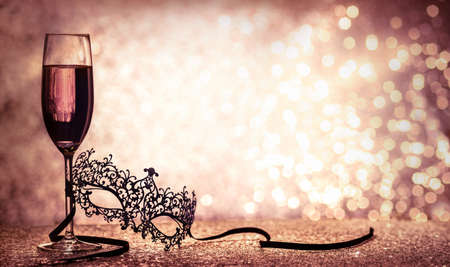 carnival mask and champagne with copy space on glittering backgroundの写真素材