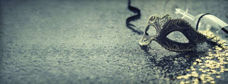 carnival mask and glass with confetti and copy spaceの写真素材