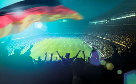 crowded football stadium with german flagの写真素材