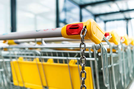 Shopping carts of a supermarket in a row, close upの写真素材