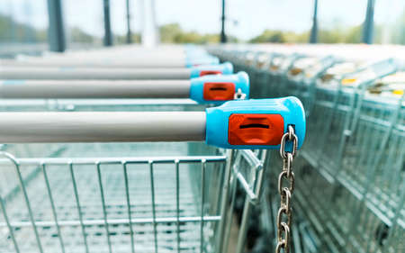 Shopping carts of a supermarket in a row, close upの写真素材
