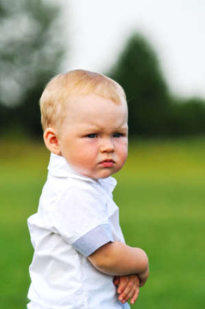 Little boy seriously looking closeup portraitの写真素材