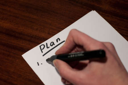 Somebody writing plan by handの写真素材