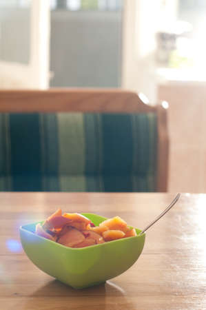 Bowl with porrige and fruits for breakfast on wooden tableの写真素材