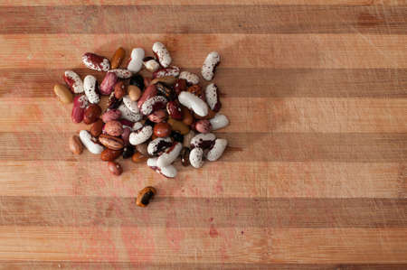 Heap of kidney beans on wooden kitchen boardの写真素材