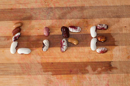 Life text from beans on wooden boardの写真素材
