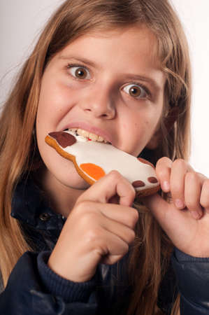Girl with tasty cookie, she eats it with passion
