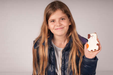 Girl with cookie portrait, she likes it very muchの写真素材