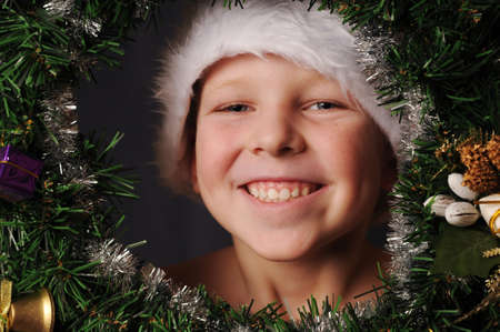 Child in Santa hat looking at camera and smilesの写真素材