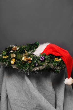 Cristmas decoration and Santa hat on grey backgroundの写真素材