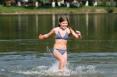 Girl is going out the water very fast with happy faceの写真素材