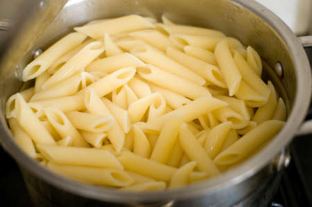 Penne pasta in saucepanの写真素材