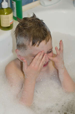 Six years child boy bathing with foam closeup portrait