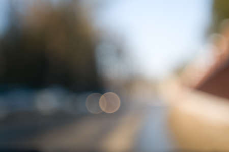Traffic abstract background with blurry buildings, street signs and carsの写真素材
