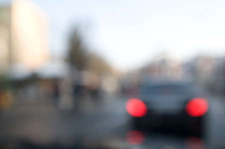 Traffic abstract background with blurry buildings, street signs and carsの写真素材