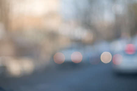Traffic abstract background with blurry buildings, street signs and carsの写真素材