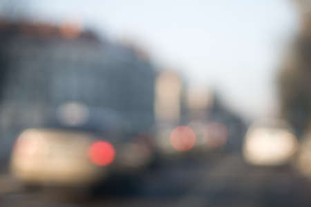 Traffic abstract background with blurry buildings, street signs and carsの写真素材
