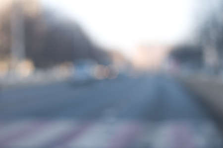 Traffic abstract background with blurry buildings, street signs and carsの写真素材