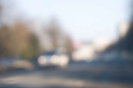 Traffic abstract background with blurry buildings, street signs and carsの写真素材