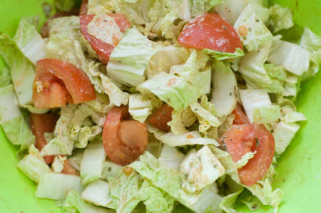 Greek salad in big green bowl closeupの写真素材
