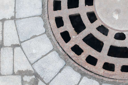 Sewer hatch on ground grey color tileの写真素材